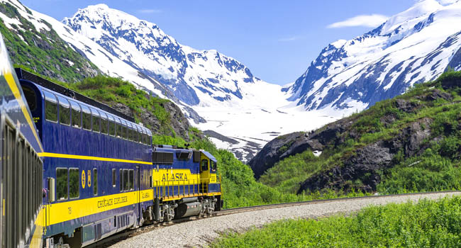 Alaska Railroad train winding past Bartlett Glacier in spring